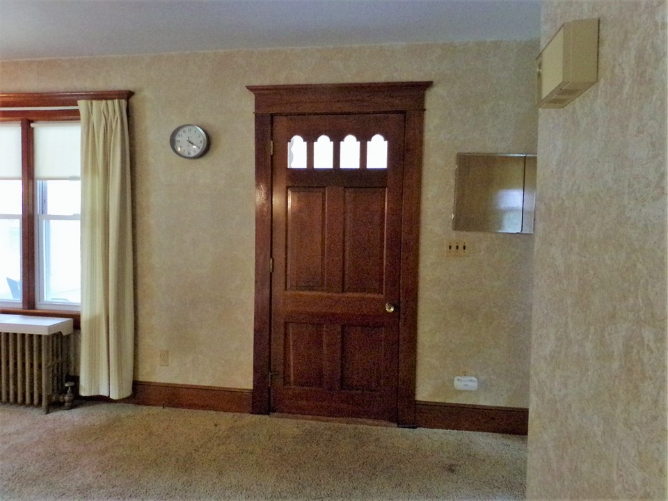 unpainted and original front door to the main living area.