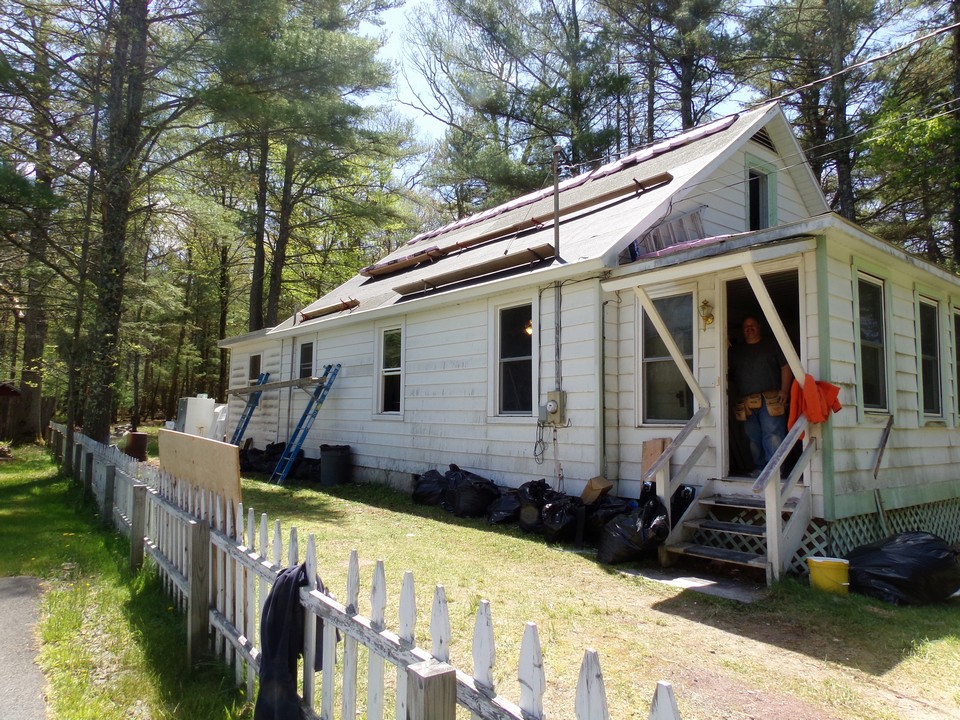 the first part of this project was to remove the layers of old roofing material and the beginning transformation of the original façade.