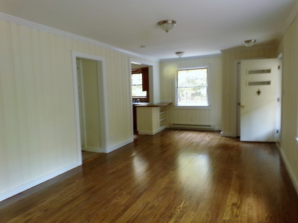 cottage open living room space with freshly sanded wooden floors.