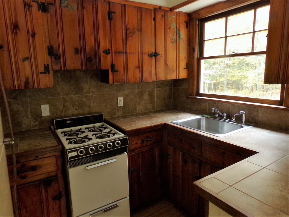 kitchenette has the warmth of yesterday right down to the hand painted details on the cabinet doors!