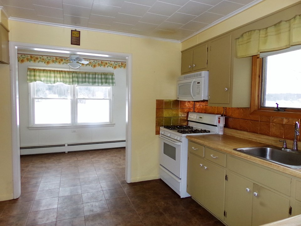 pretty kitchen eat in kitchen explores the open spaces through large lake view windows.