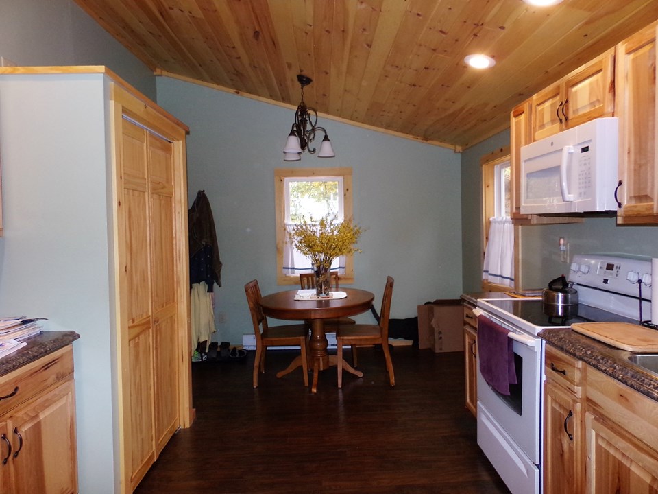 vaulted ceilings pantry space was added to when an older closet was removed and widened. natural tones work with the dark floors.