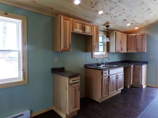 new kitchen a fresh new kitchen was re create with oak cabinetry and up to date fixtures.