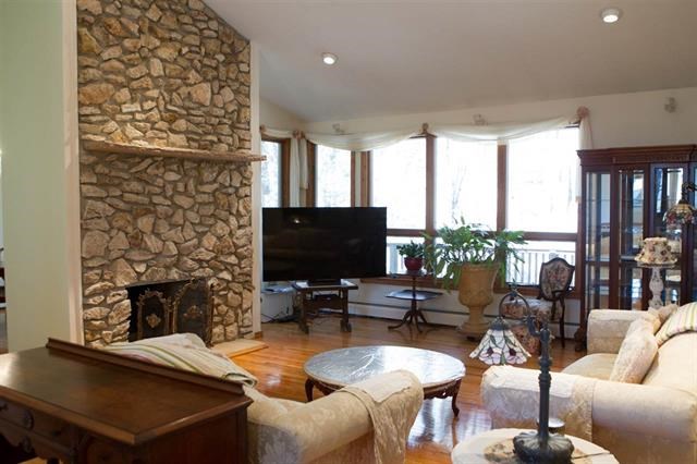 vaulted ceilings! vaulted ceilings, hard wood flooring , open and inviting with extra large windows to take in views of the waterfall and the glen.